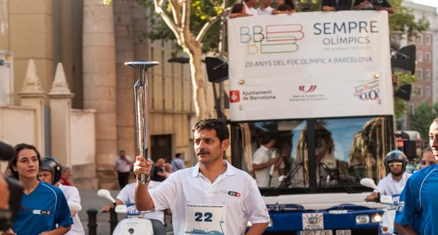 El periodista Xavier Bonastre, en un moment del seu relleu, seguit del bus turístic / Pep Herrero